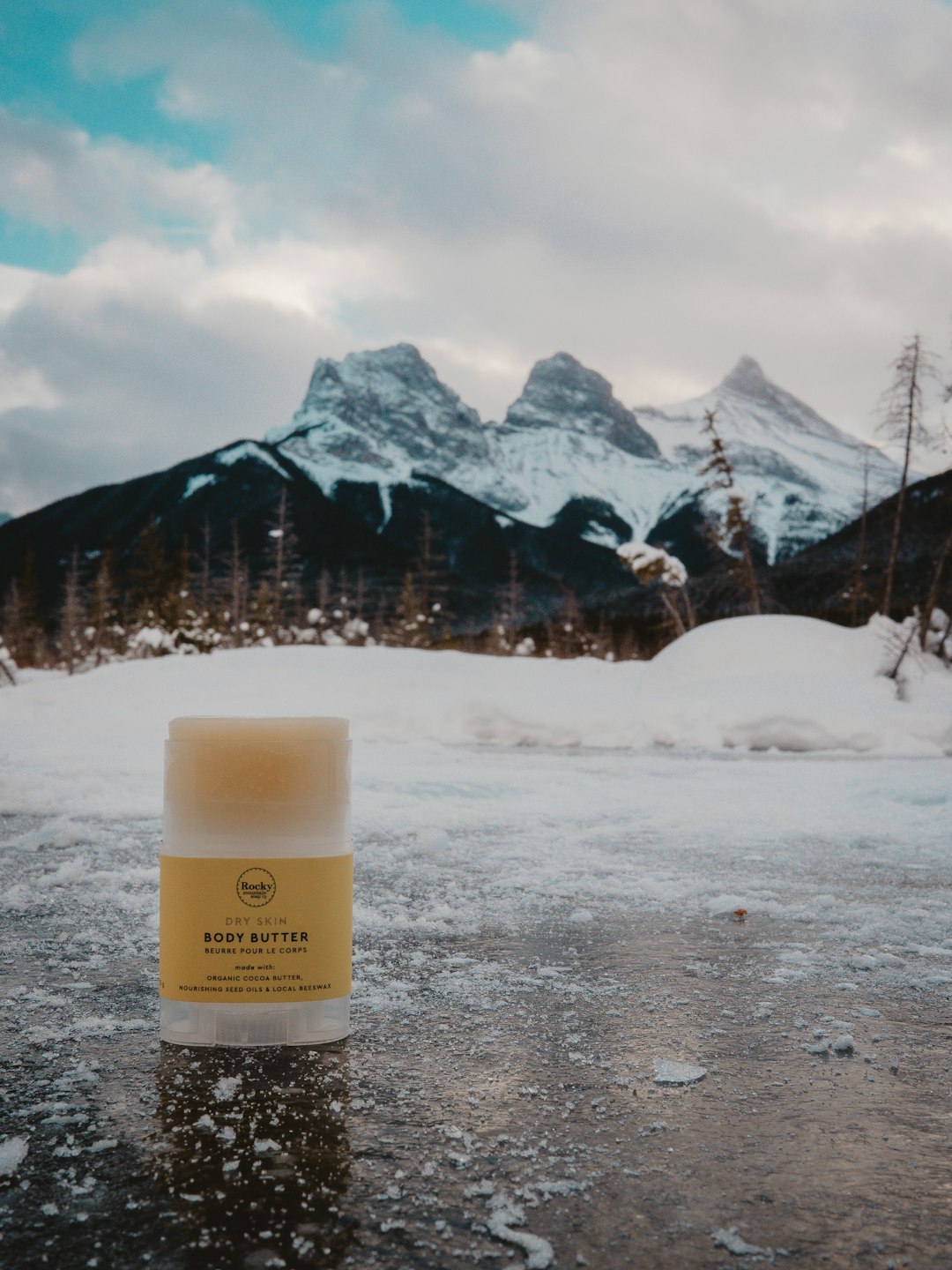 yellow labeled bottle on grey snow covered surface