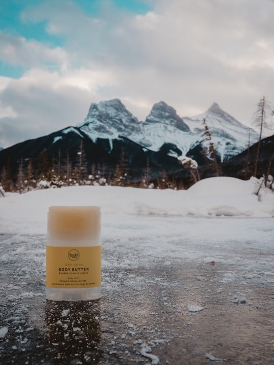 yellow labeled bottle on grey snow covered surface in The Three Sisters Canada