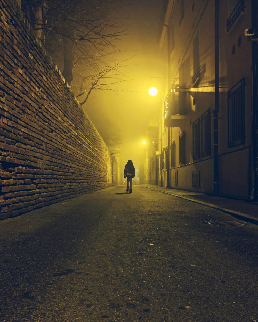 a person walking down a street at night