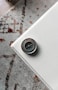 silver-colored compass on edge of white table