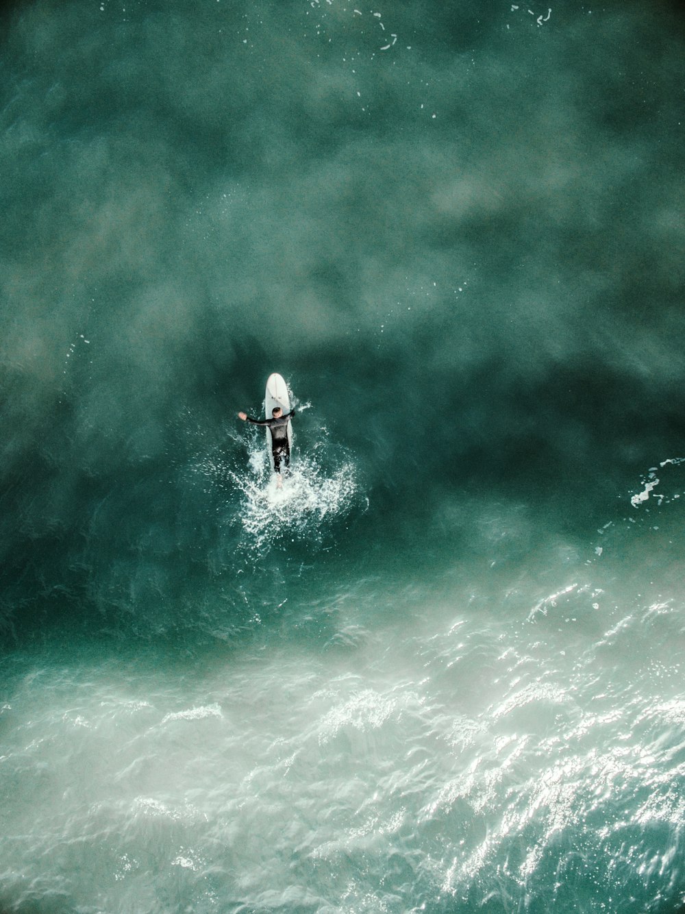 aerial photography of man riding a kayak