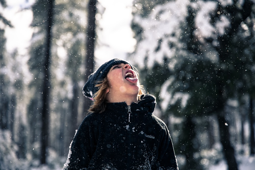 time-lapse photography of snow pouring on man's mouth