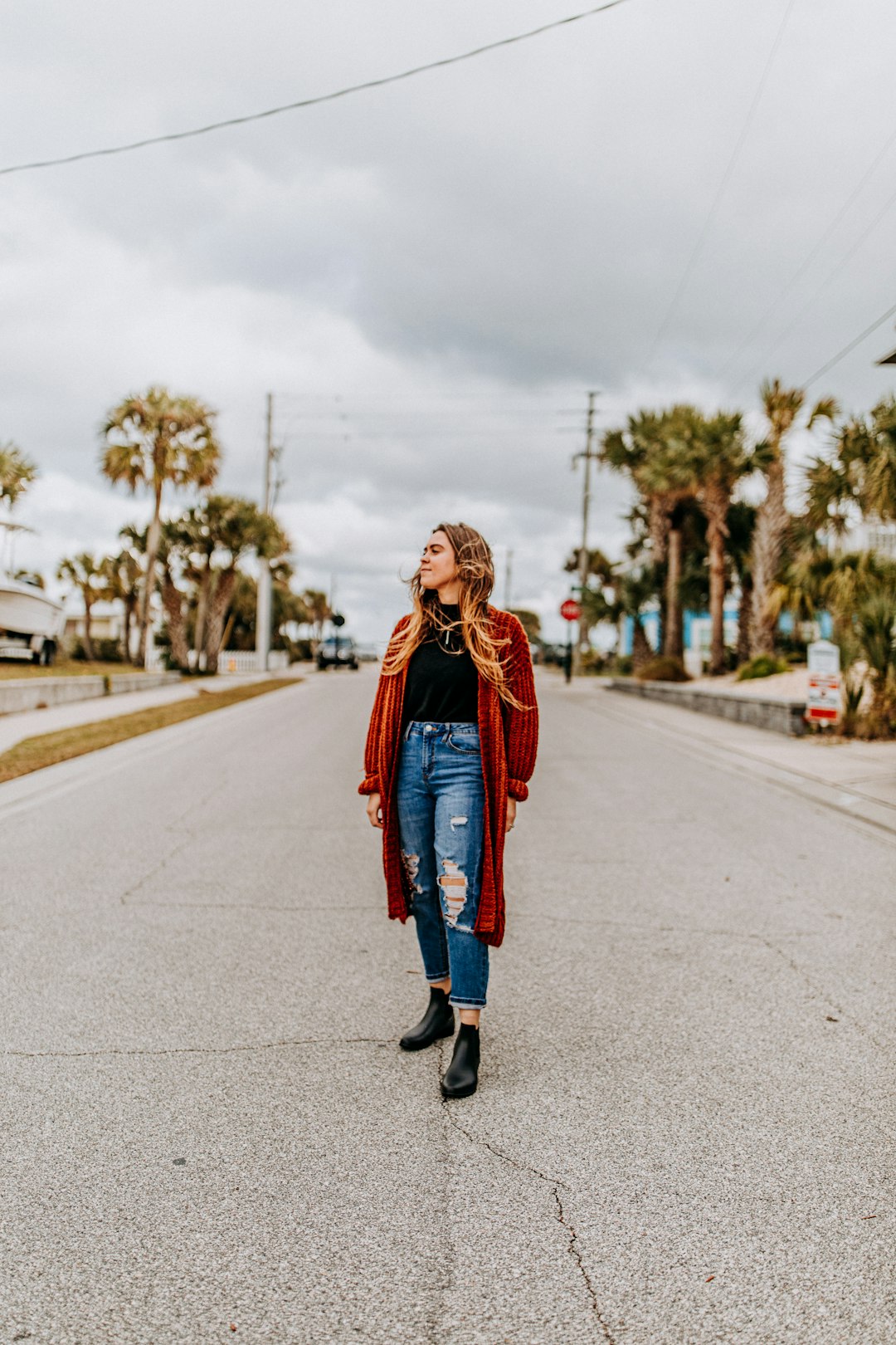 woman standing on the middle of the road