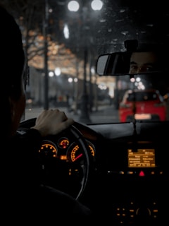 person driving car at night