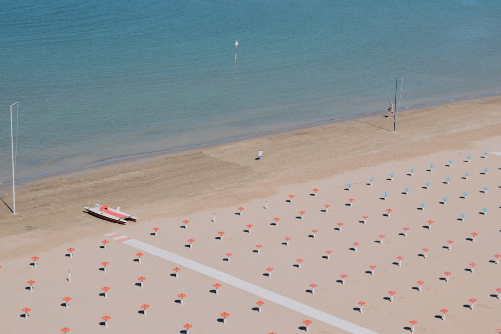 person and boat on shore during day