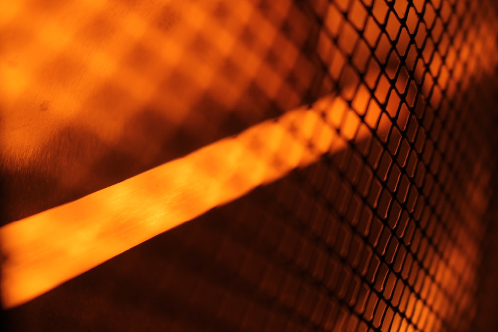 selective focus photography of a metal screen