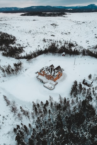 A satellite view of a sprawling bitcoin mining data center nestled in the snowy landscapes of Finland.