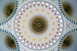 Wide shot of a mosque dome decorated with complex calligraphy patterns.