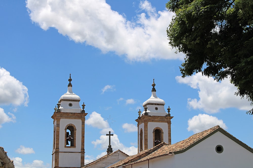 low-angle photography of white and brown church