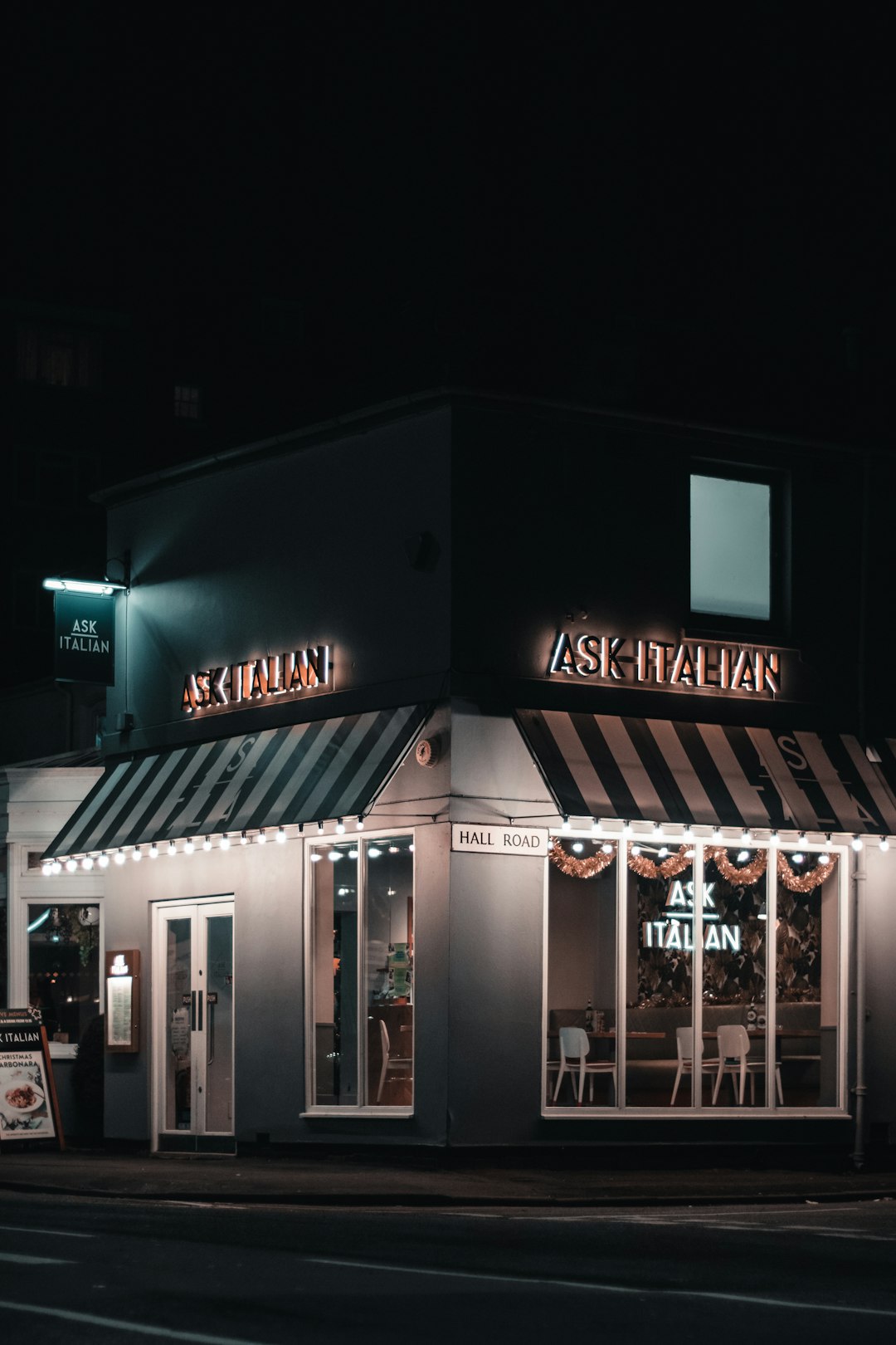 turned-on lights of an Italian restaurant building