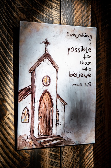 Illustration of a rustic church with a cross atop, featuring arched windows and a wooden door. The artwork is complemented by an inspirational quote from Mark 9:23 in a handwritten style, set against a textured background.