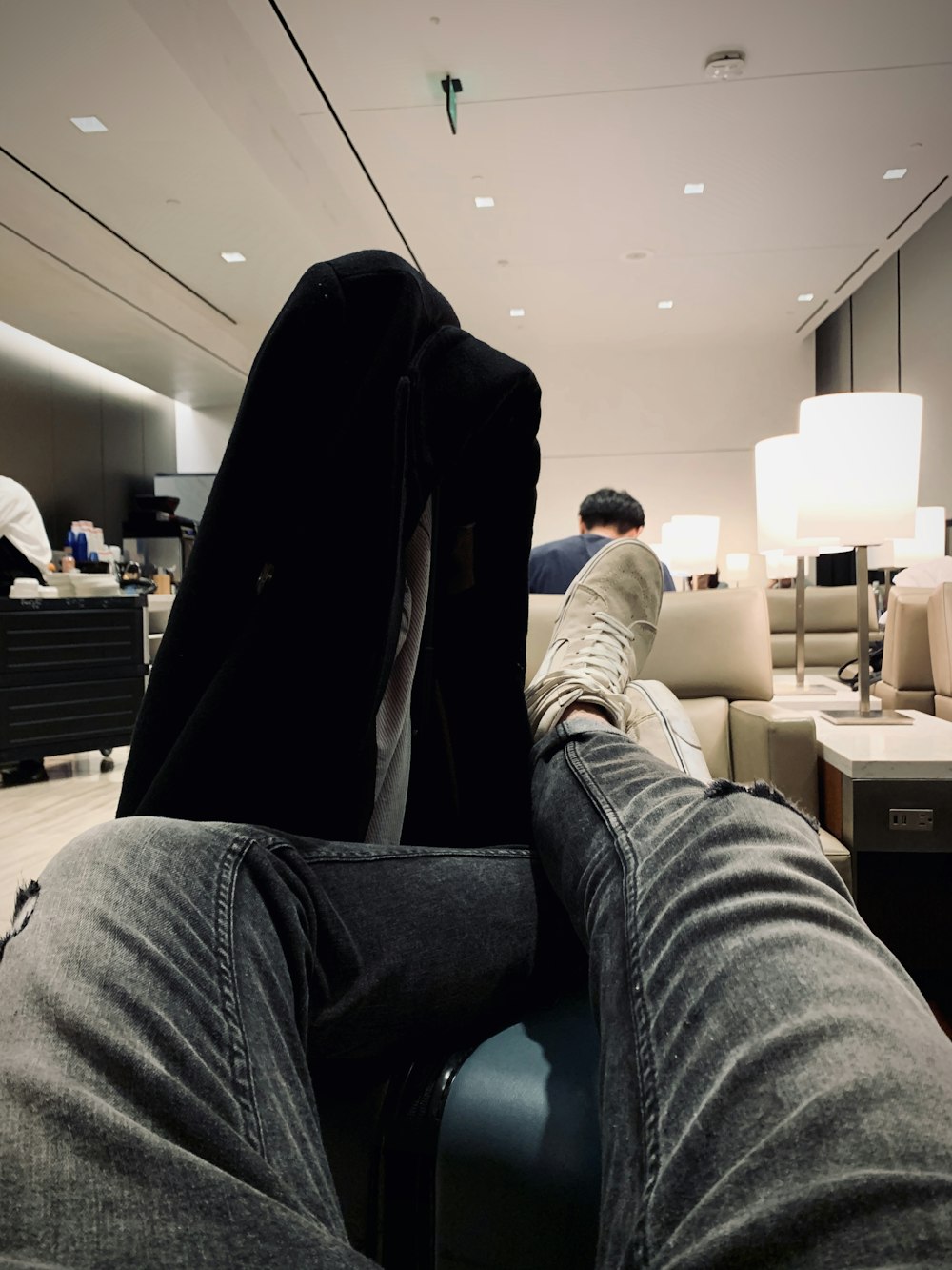 a person with their feet up on a chair