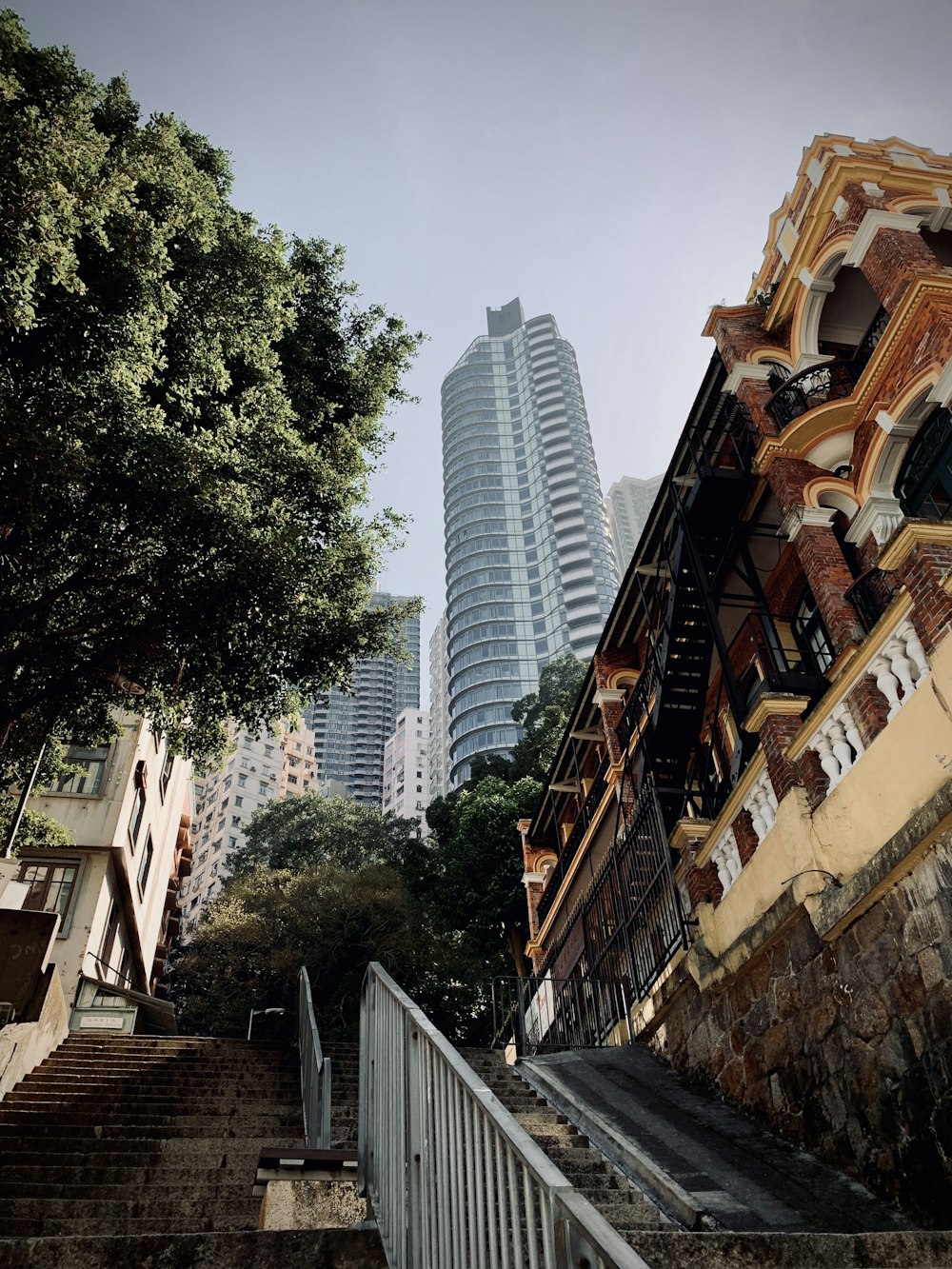 green trees beside brown concrete building during daytime