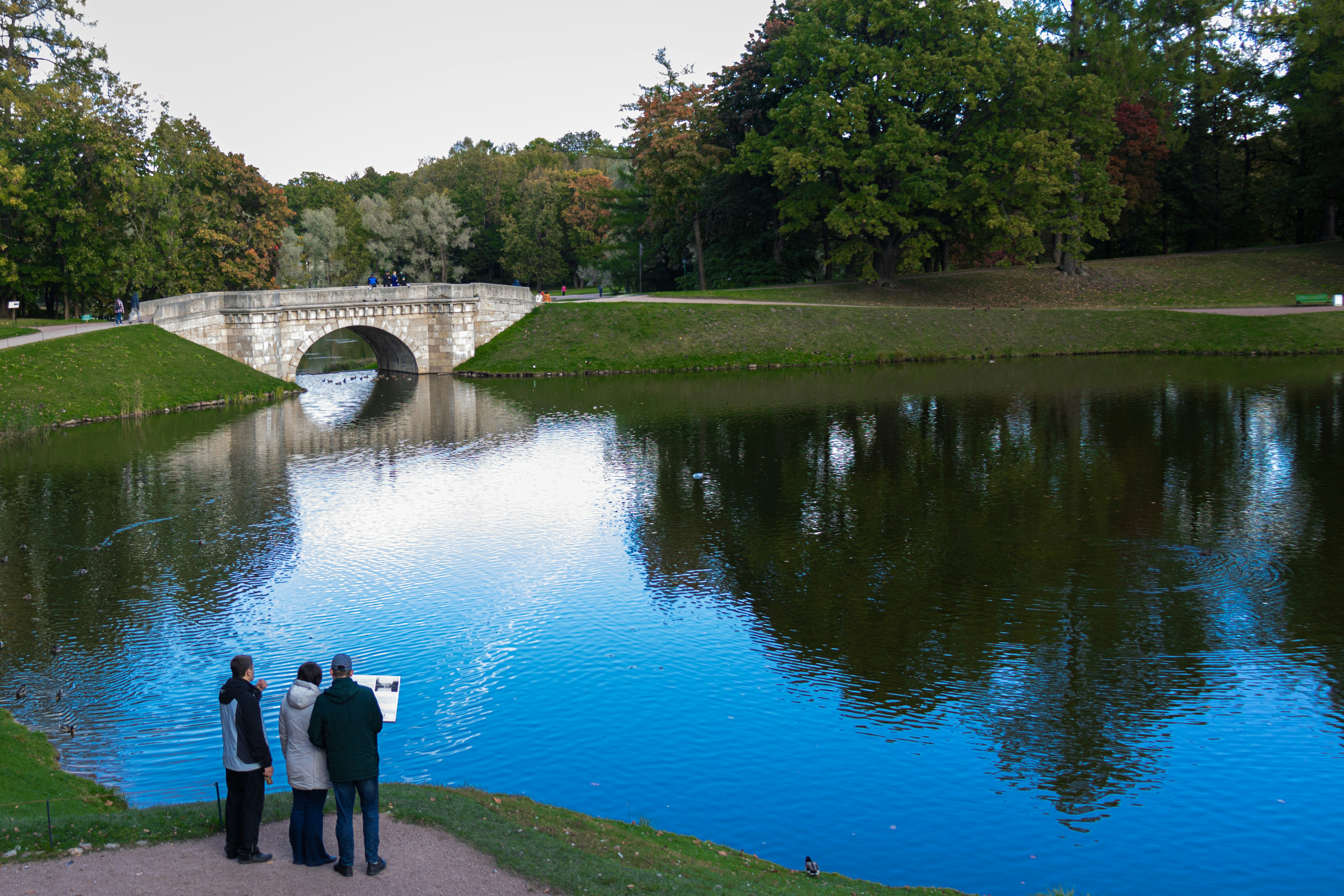 person standing in front of body of water during daytime