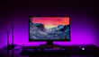 A high-resolution curved monitor displaying a vivid nature scene.