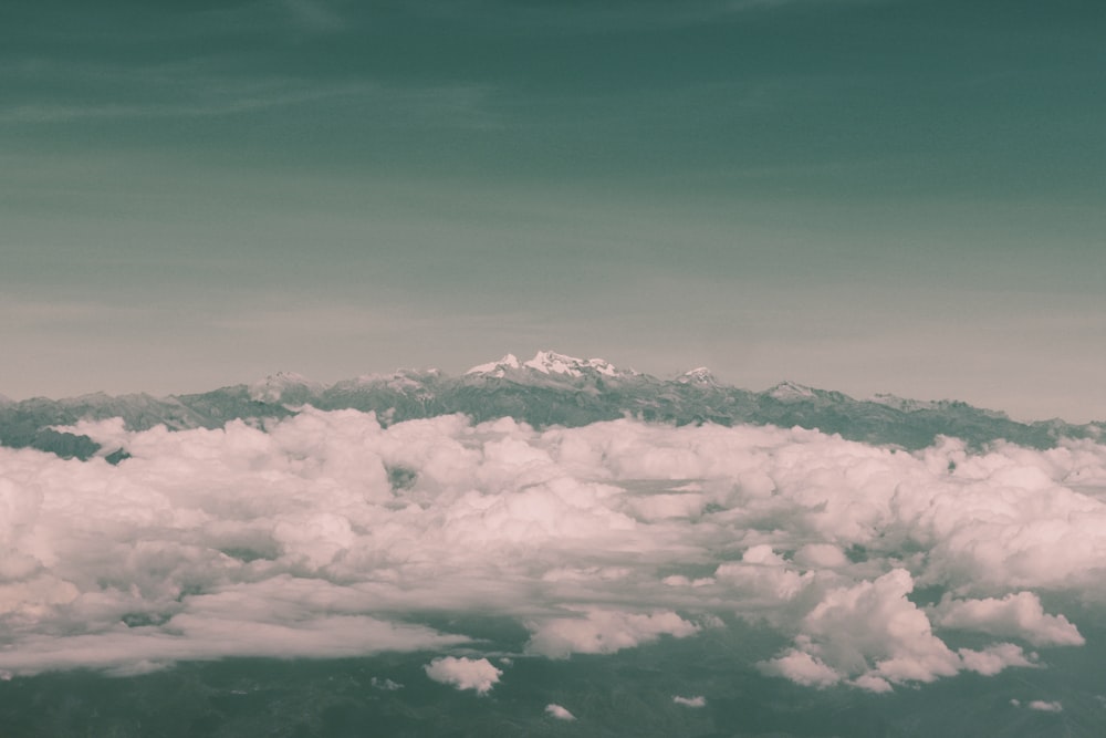 white clouds near mountains during day