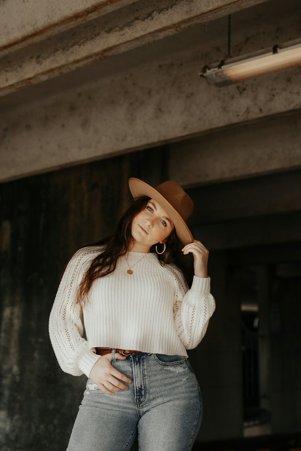 woman holding her hat