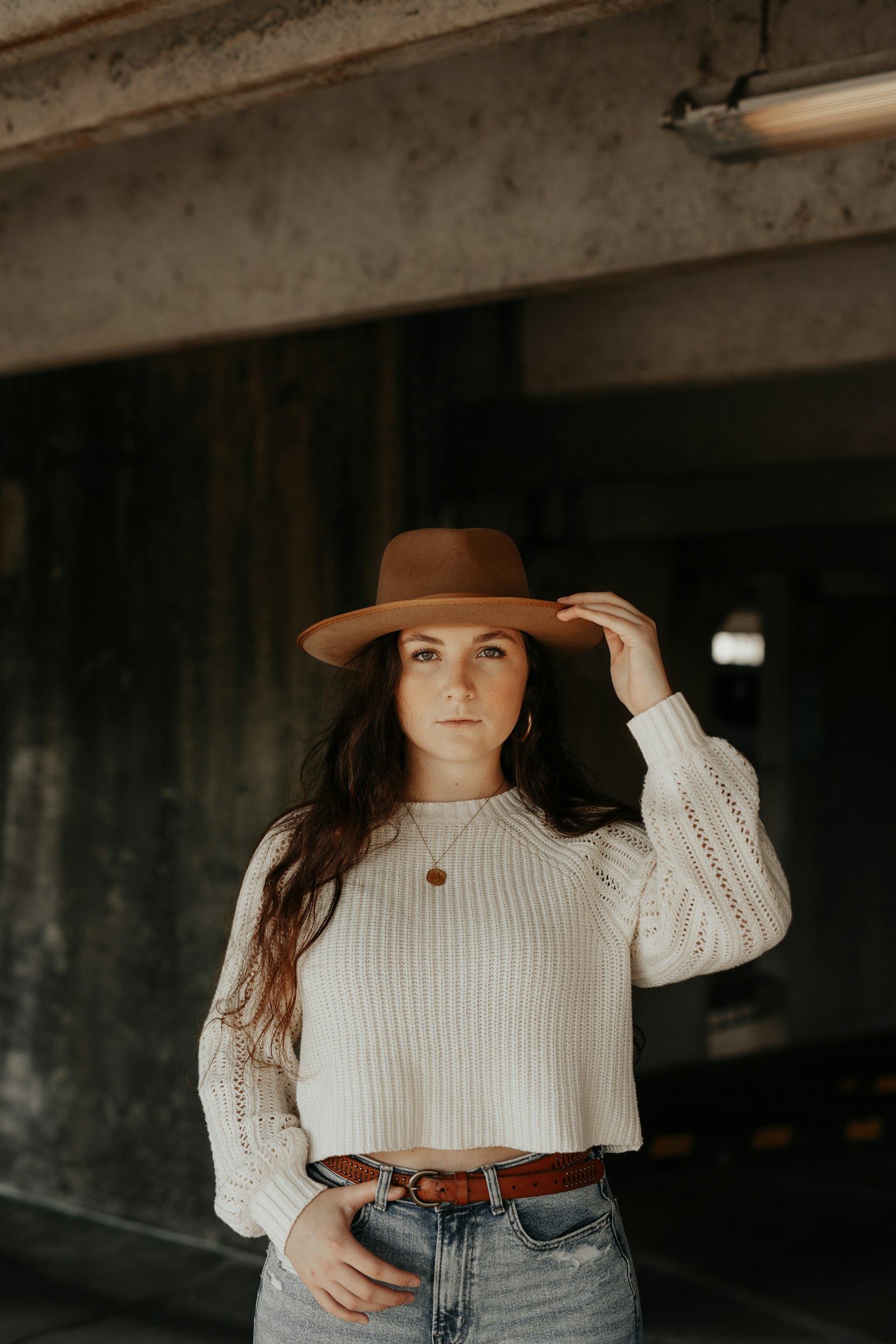 Tokina Opera 50mm F1.4 FF sample photo. Woman wearing brown cowboy photography