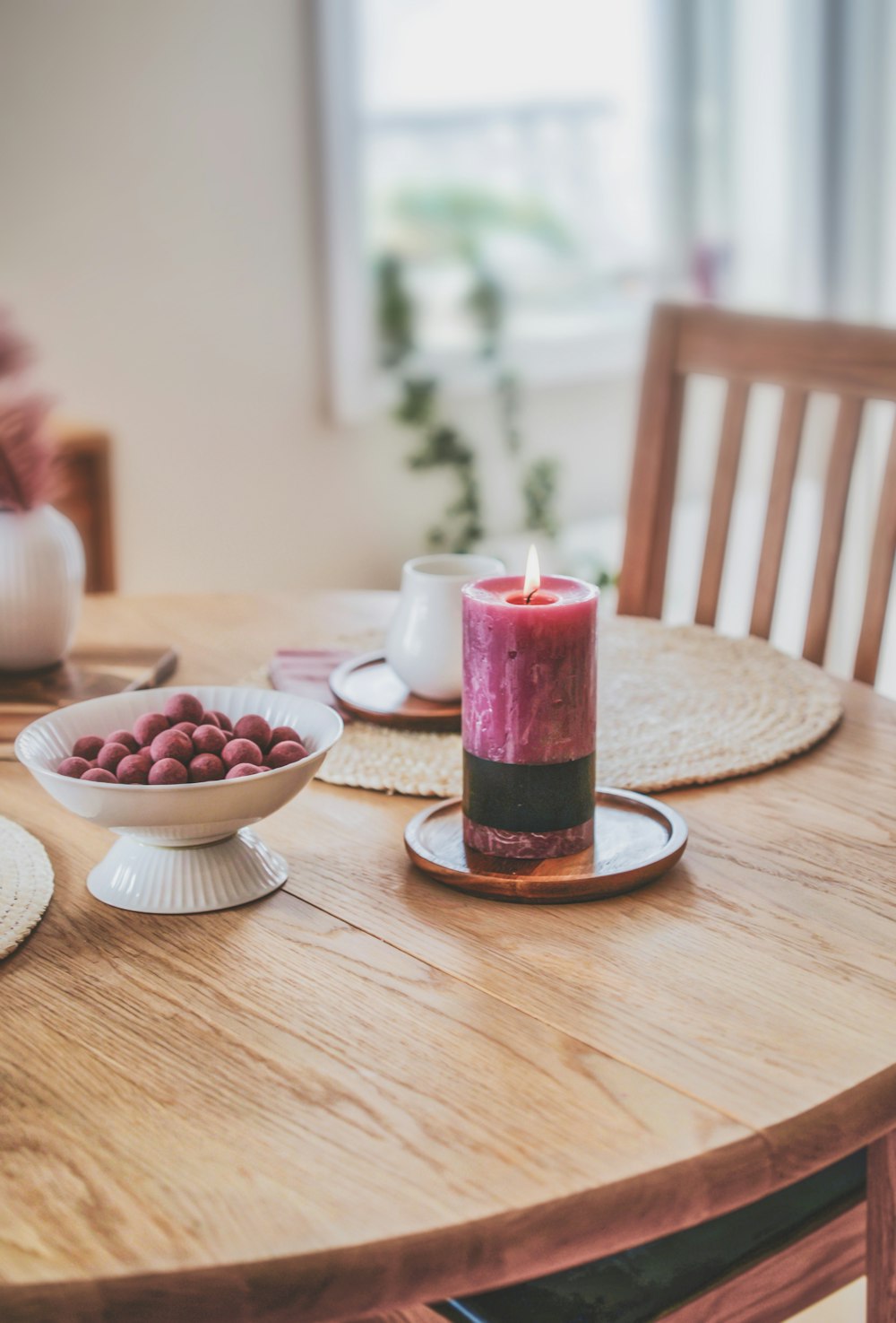 shallow focus photo of lighted purple pillar candle