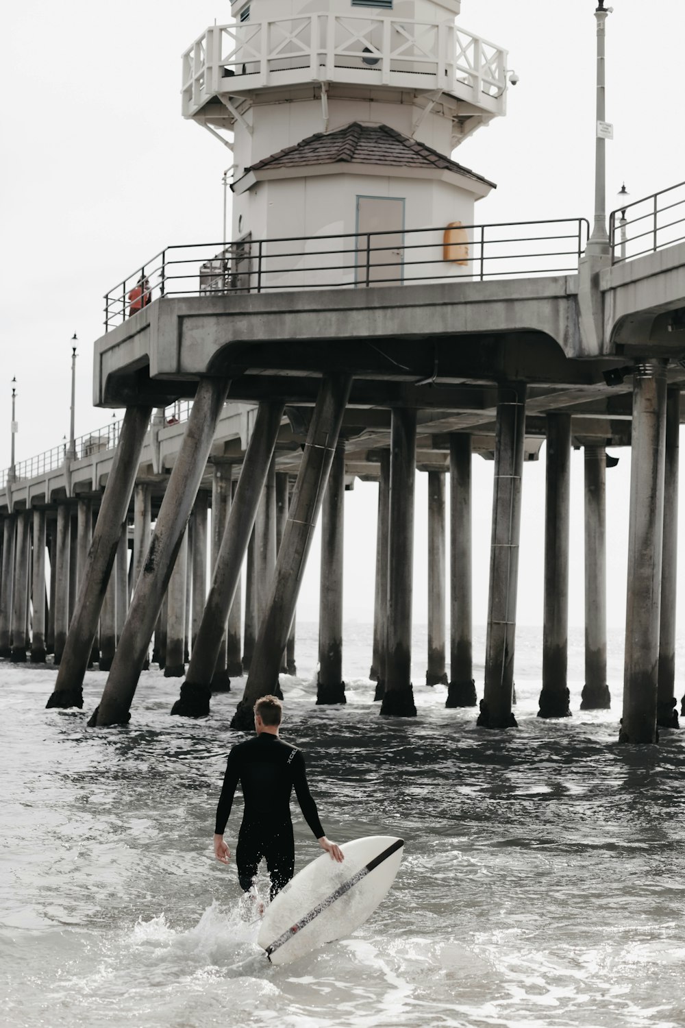 person holding white surfboard in body of water