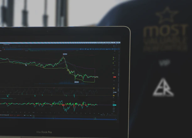A hotel manager reviewing dynamic pricing charts on a laptop in a cozy office.