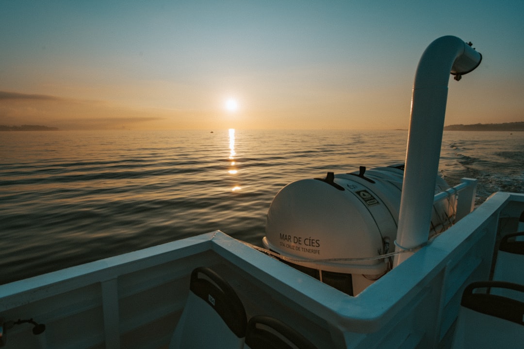 white boat during sunset