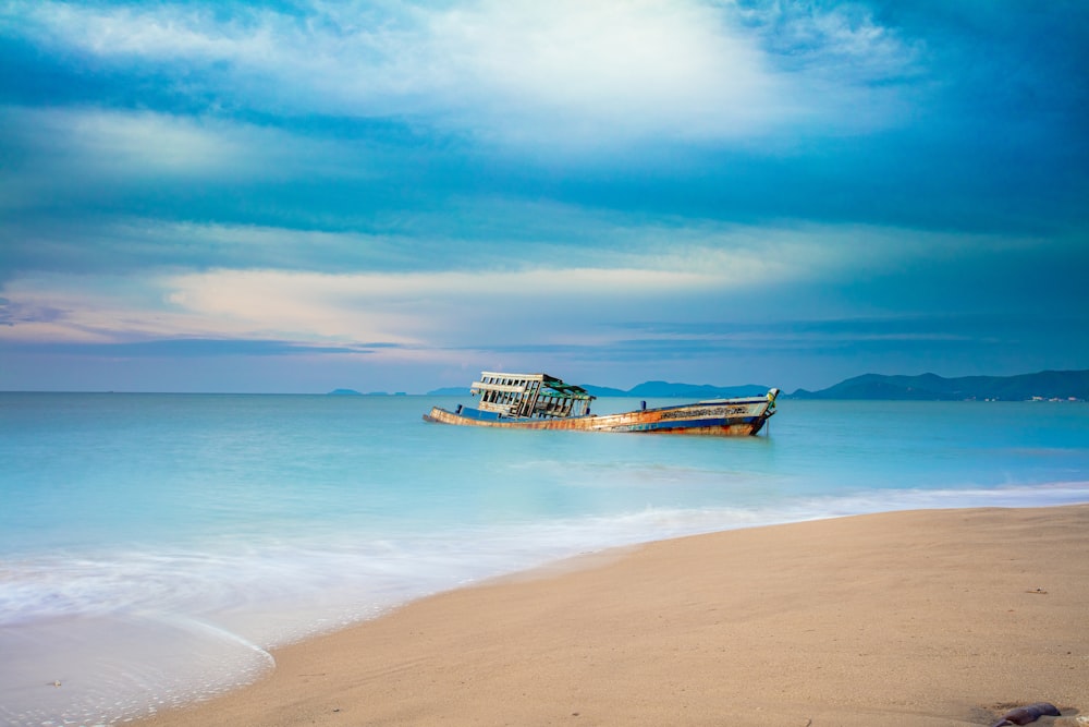 brown boat near seashore