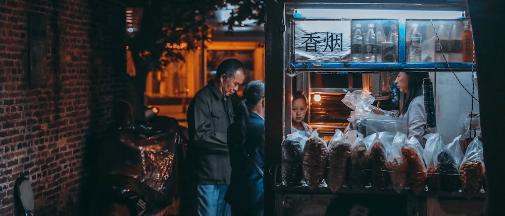 a man and woman standing in front of an oven