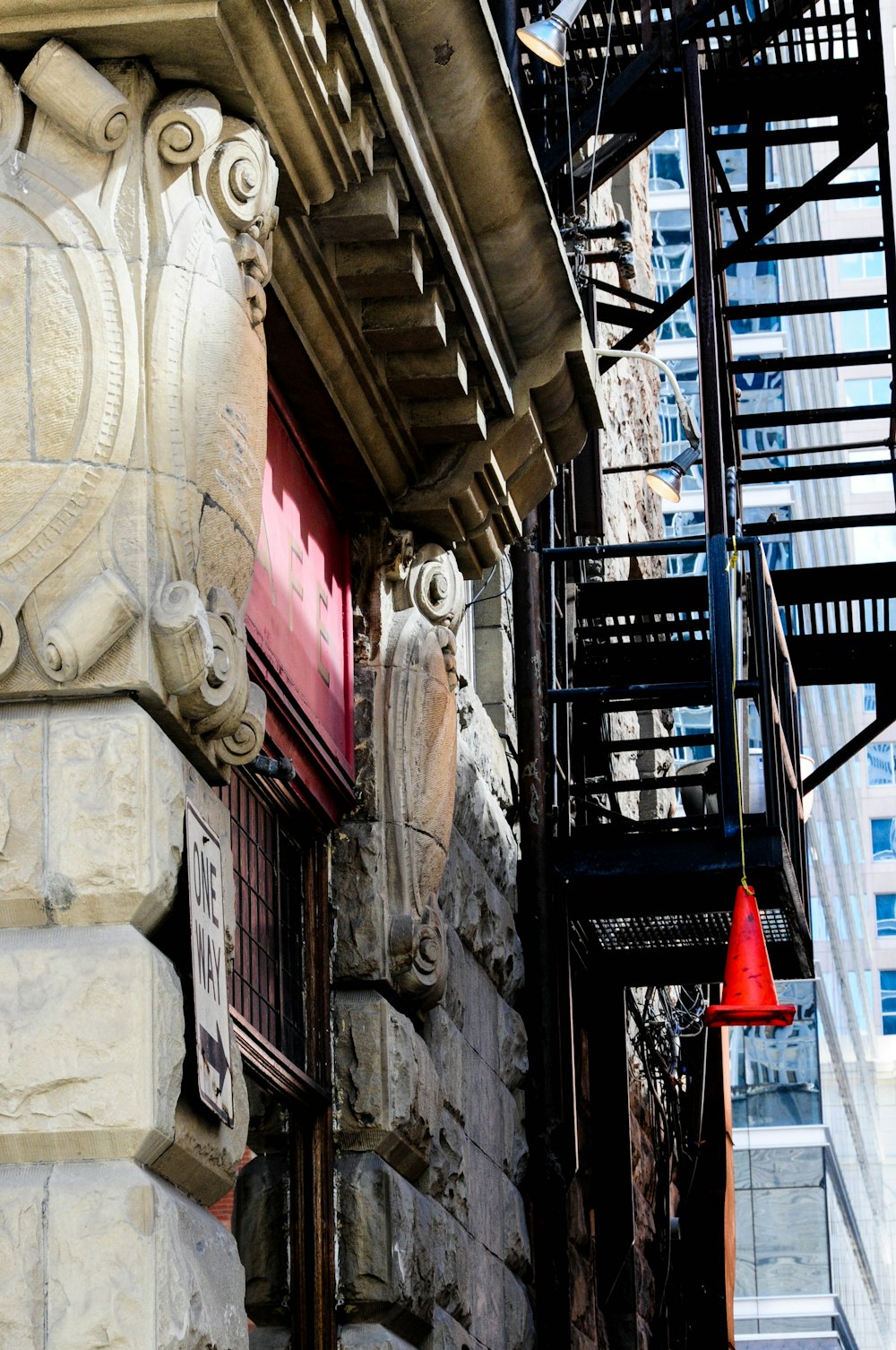 a red fire hydrant sitting on the side of a building