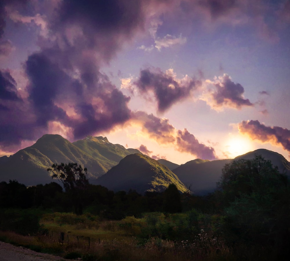 white clouds over hills