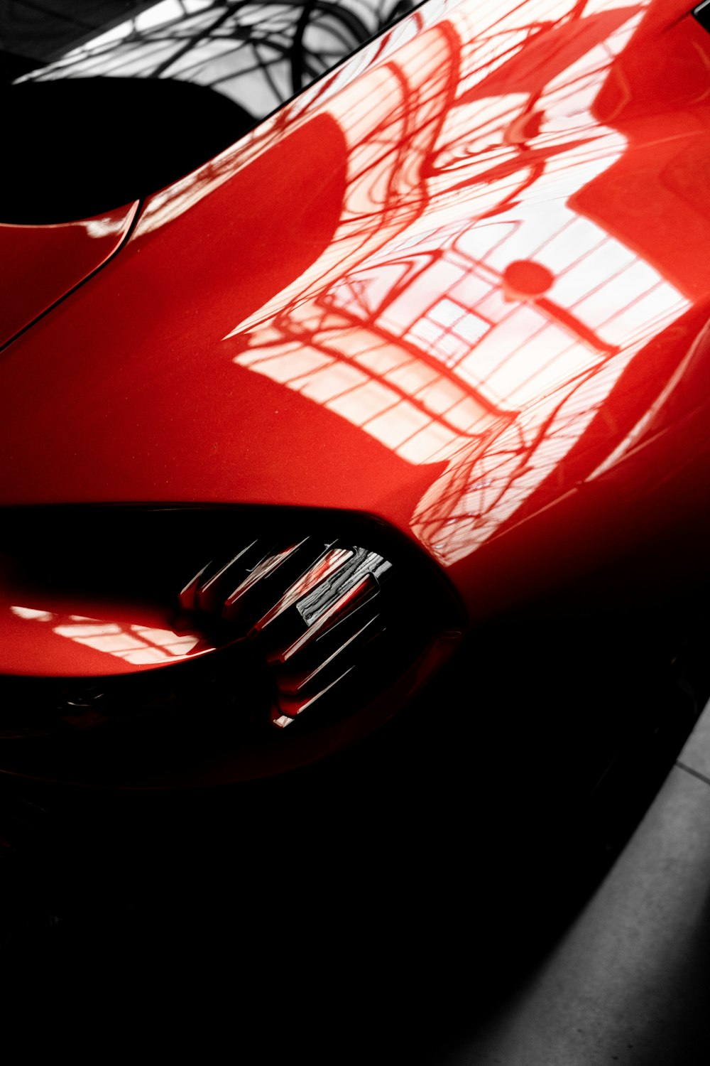 a close up of the front of a red sports car