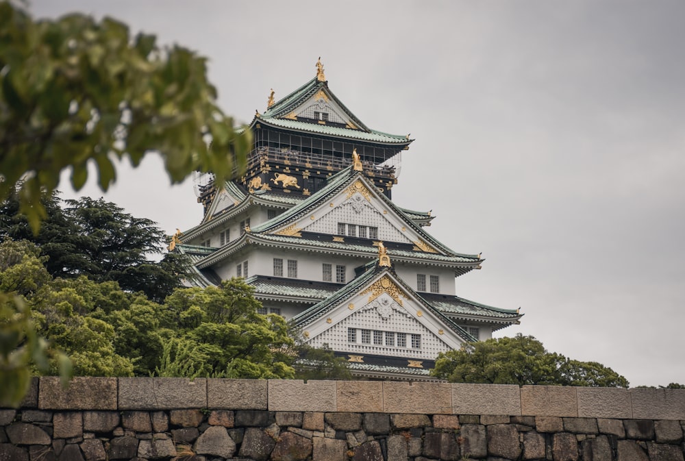 white and gold temple near trees during day