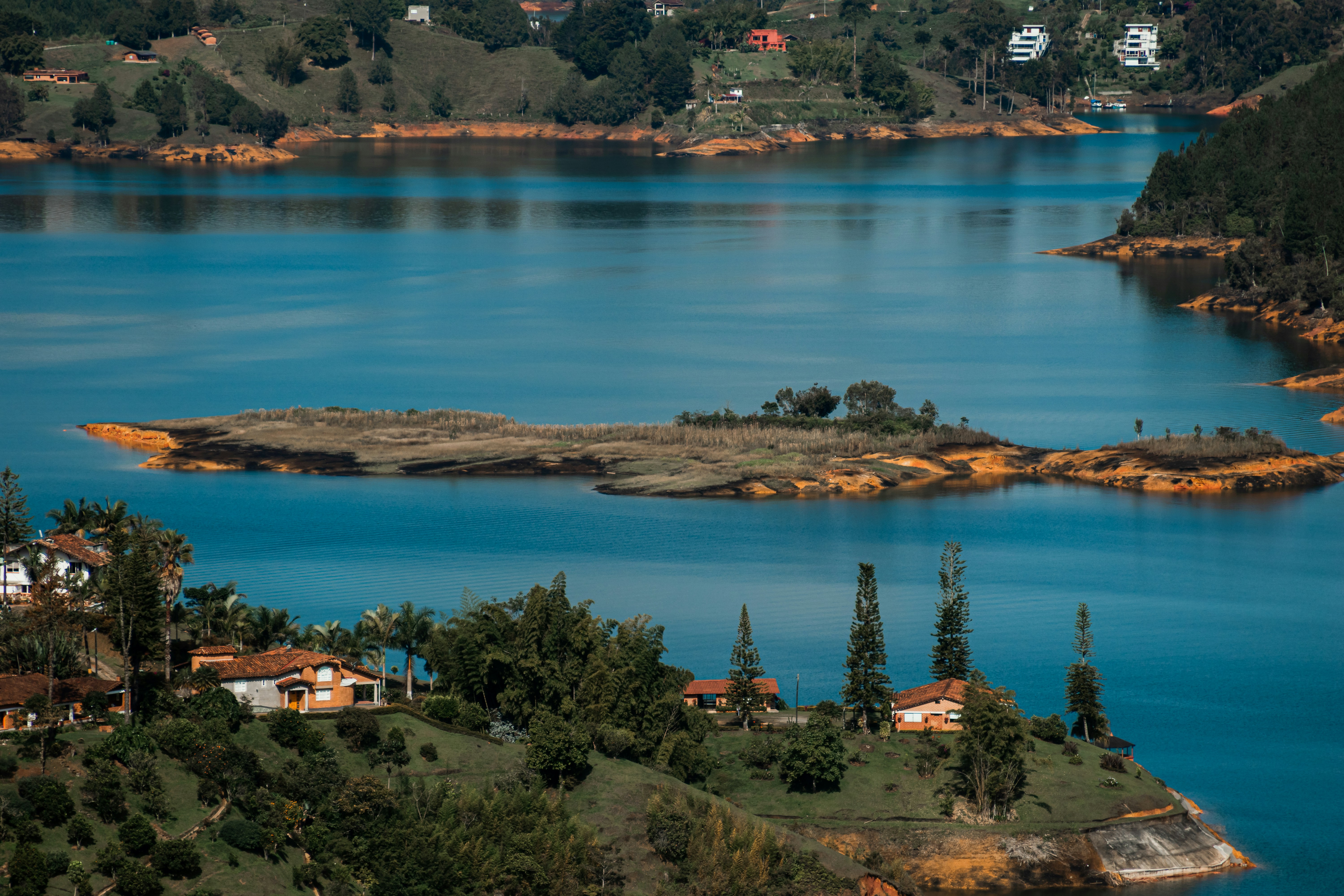 houses beside body of water during daytime