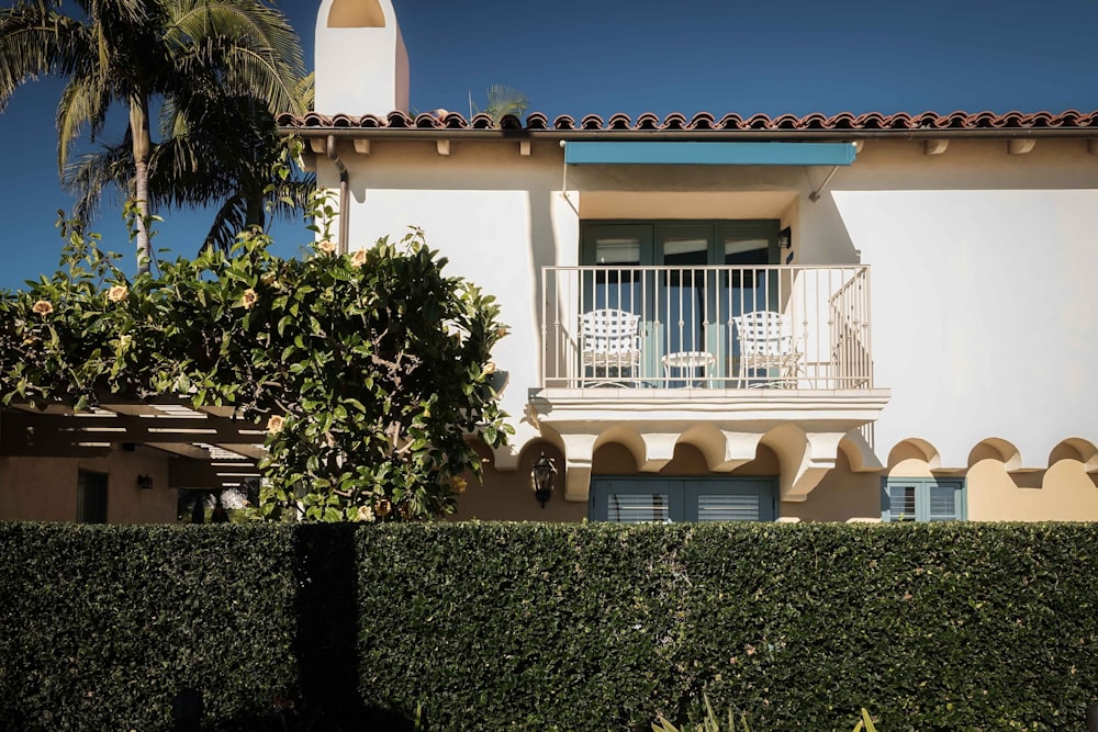 a white building with a balcony and balconies