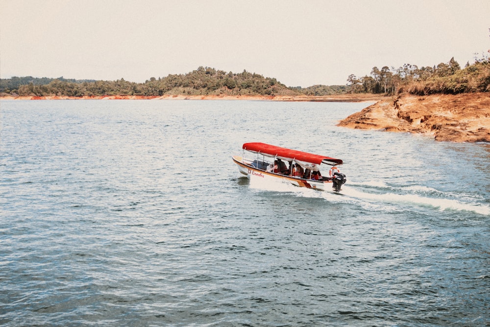 people riding white speedboat during daytime