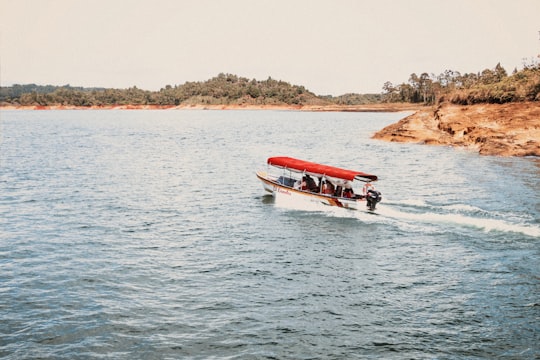 people riding white speedboat during daytime in Guatapé Colombia