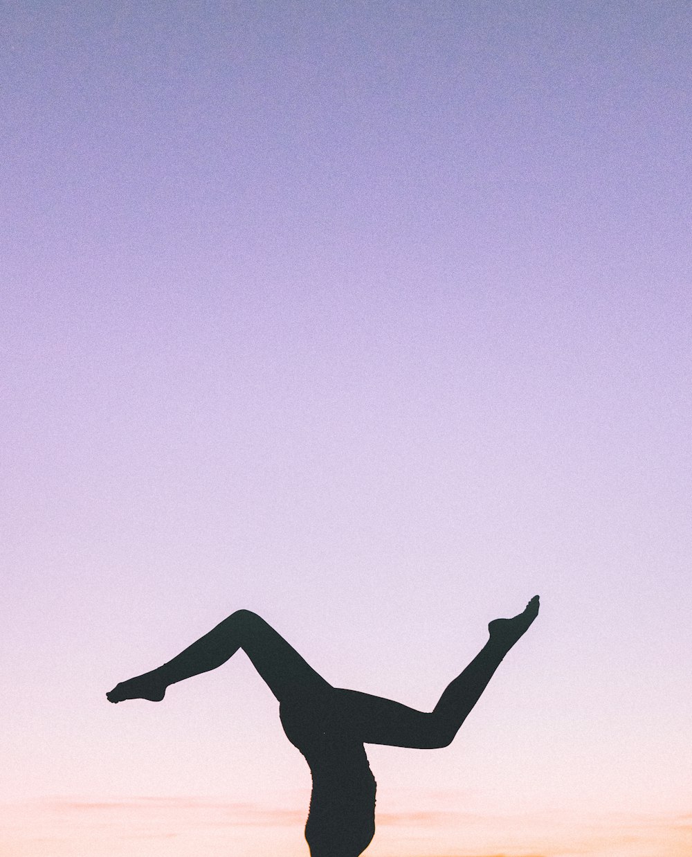 silhouette photography of person doing cartwheel