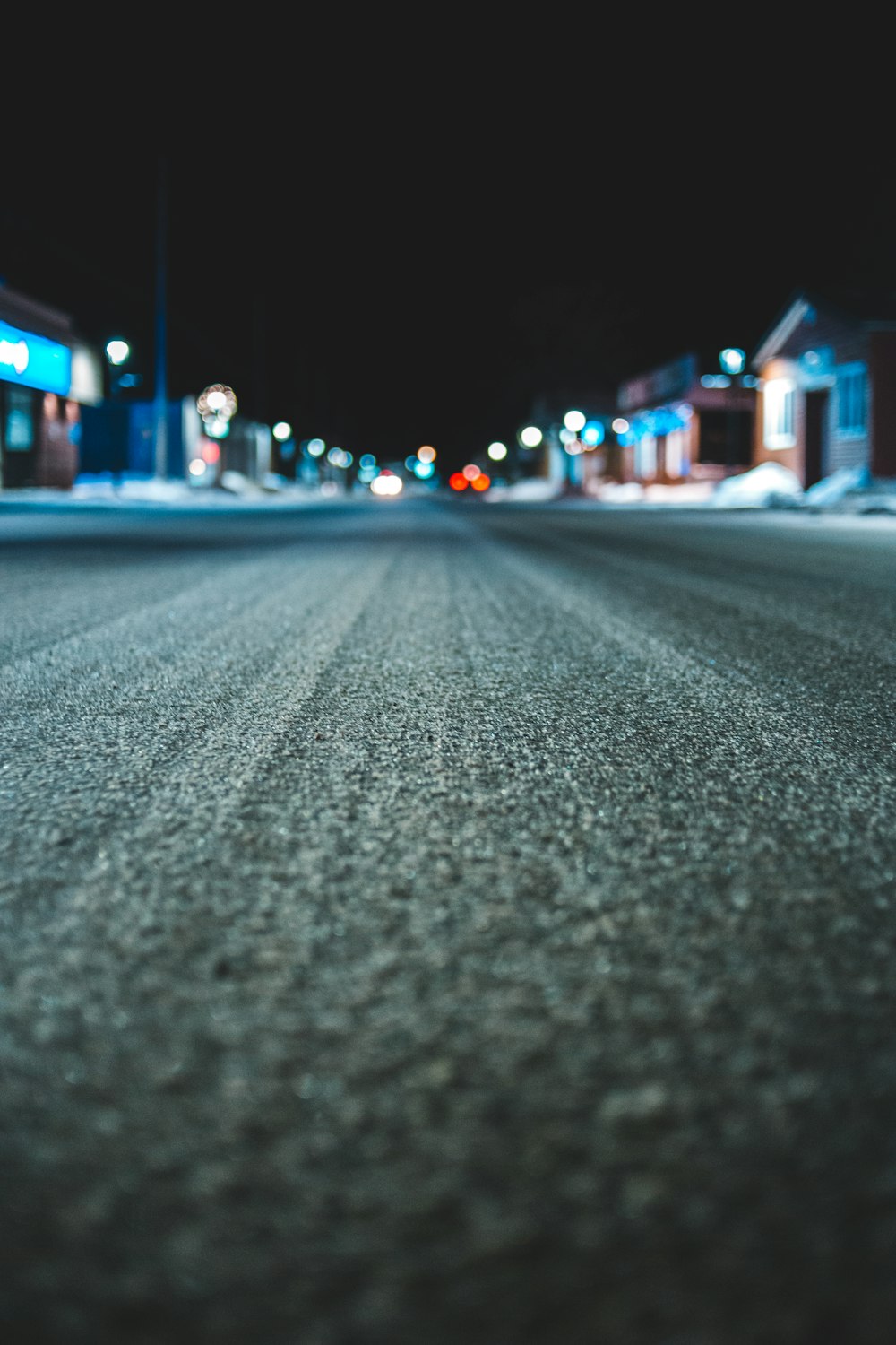 an empty street at night with no cars on it