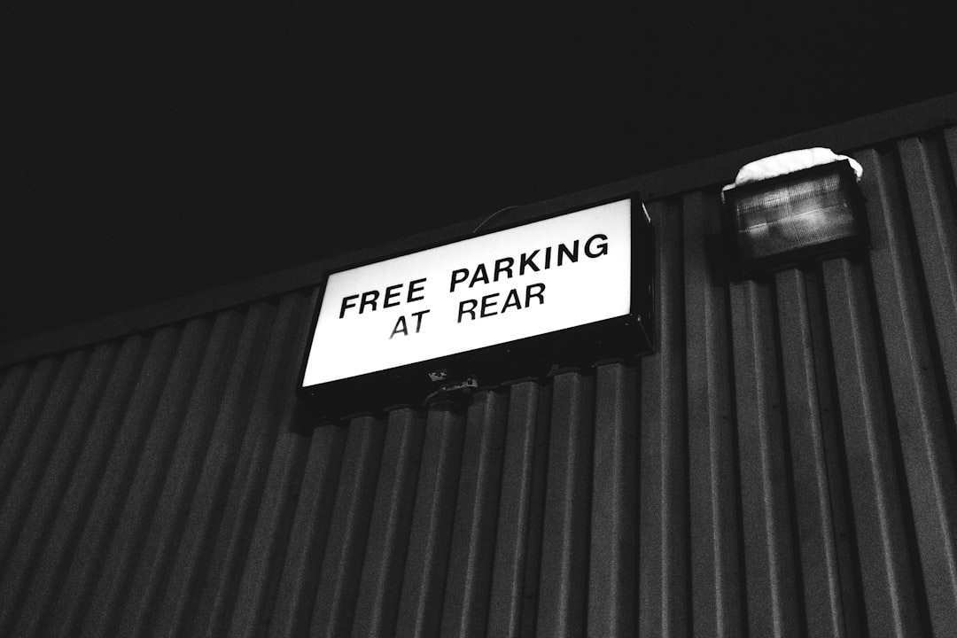 grayscale photography of free parking at rear sign