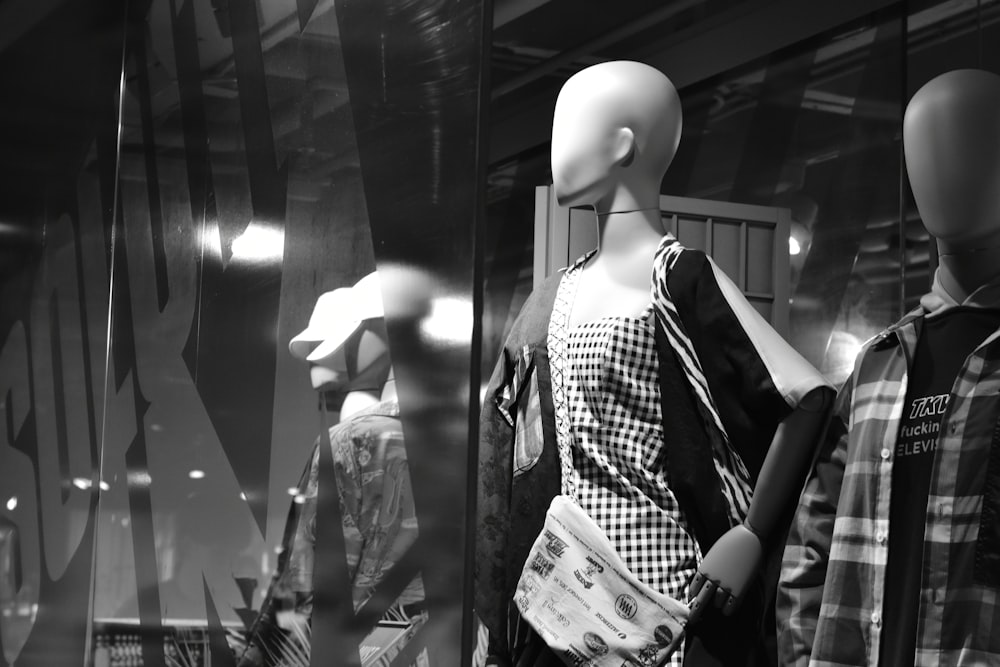 grayscale photo of mannequin with dresse s