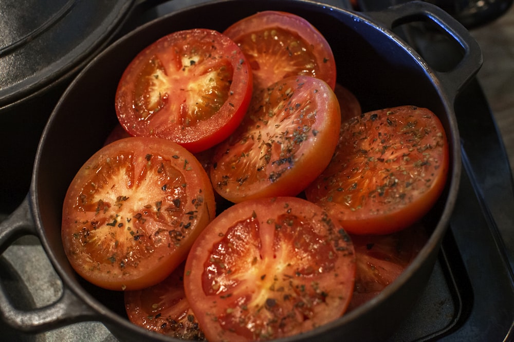 slices of tomato on black pot