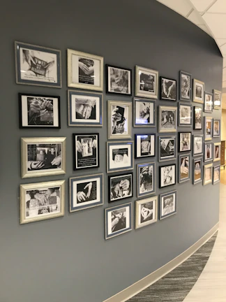 A wall display featuring photos and descriptions of completed client projects.