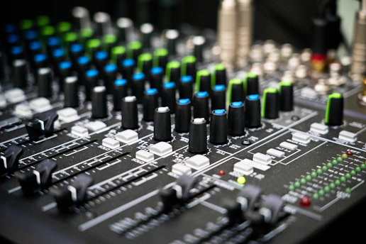 Close-up of a professional church audio mixing console with colorful LED indicators