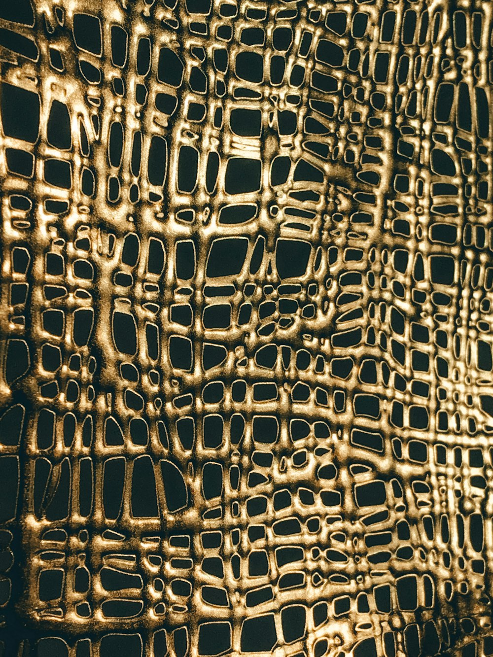 a close up of a wall made of gold foil