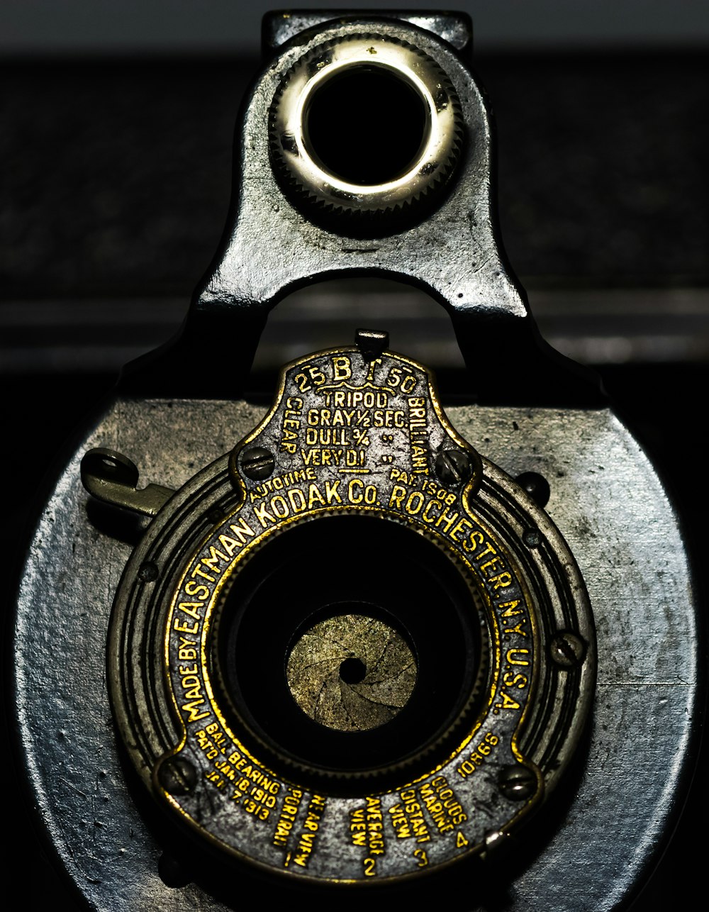 a close up of a metal object with a black background