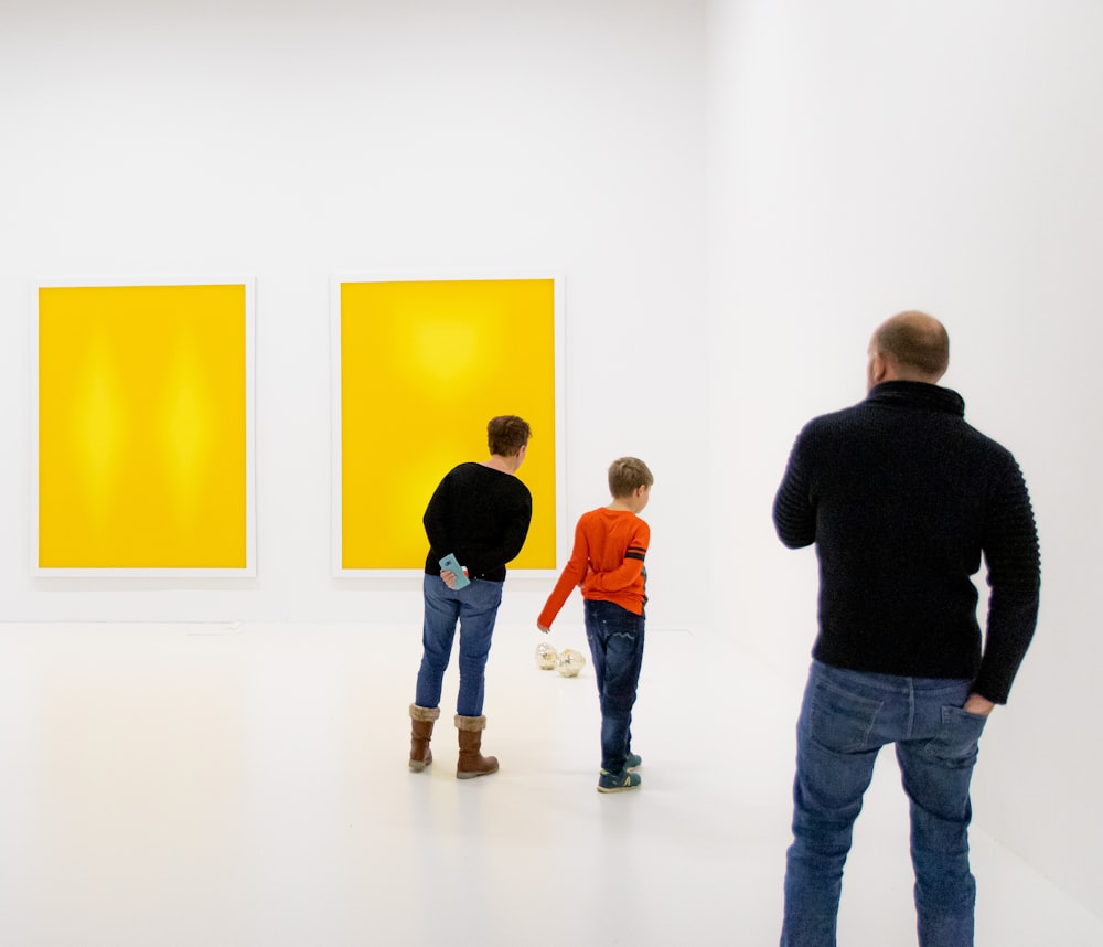 people standing in white painted room