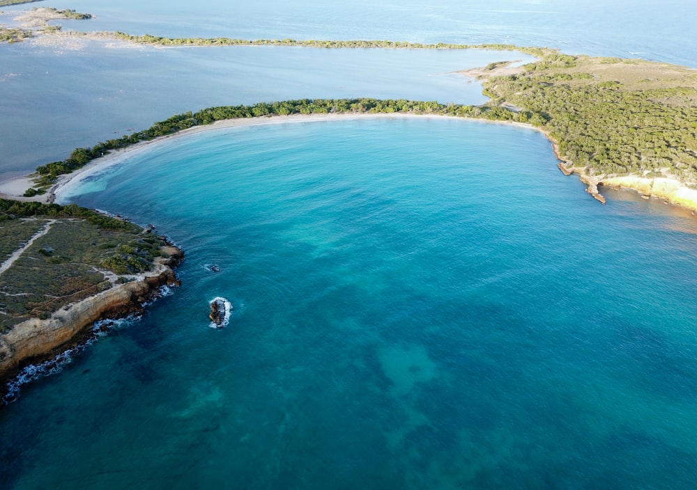 aerial photography of blue body of water near island during daytime