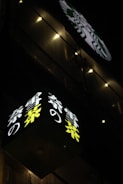Nighttime shot of a corner building illuminated by colorful FOOH advertisements.