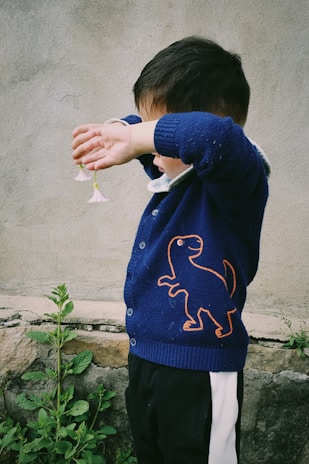 boy wearing blue and white sweatshirt