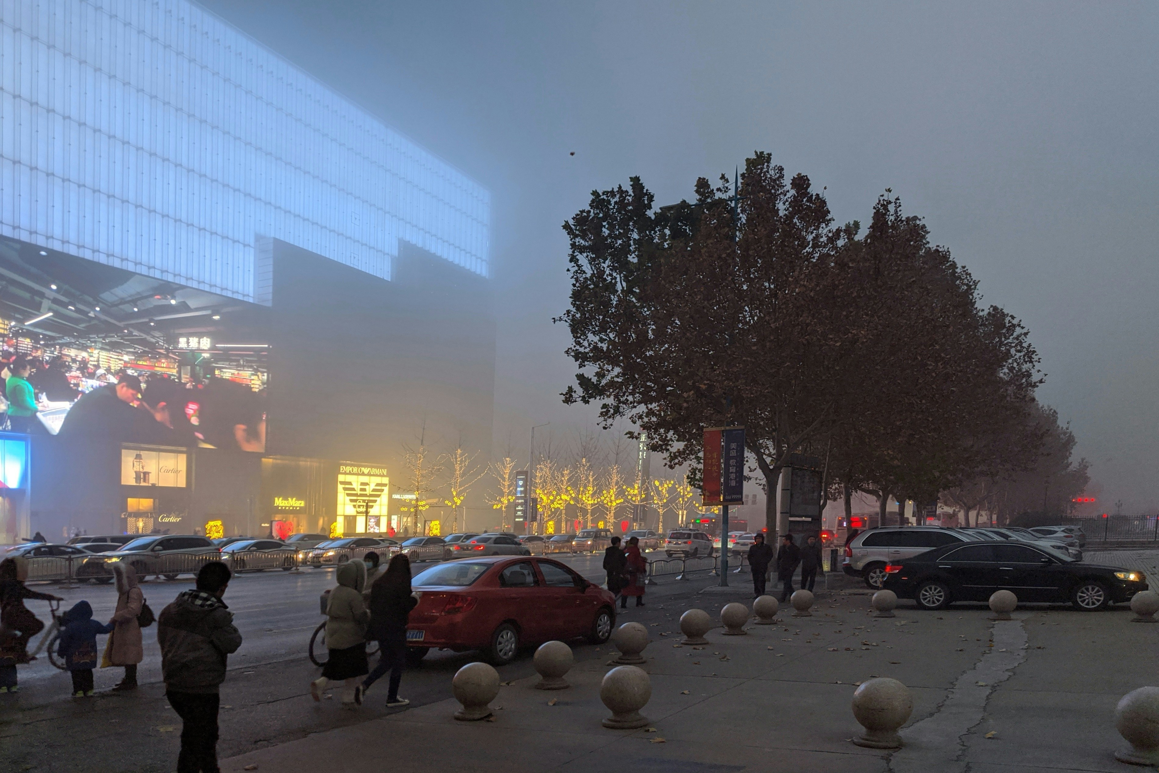 people on the street near vehicle and building during nighttime